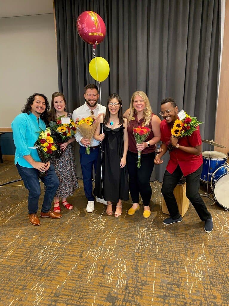 A group of Mirabella at ASU musicians holding flowers.